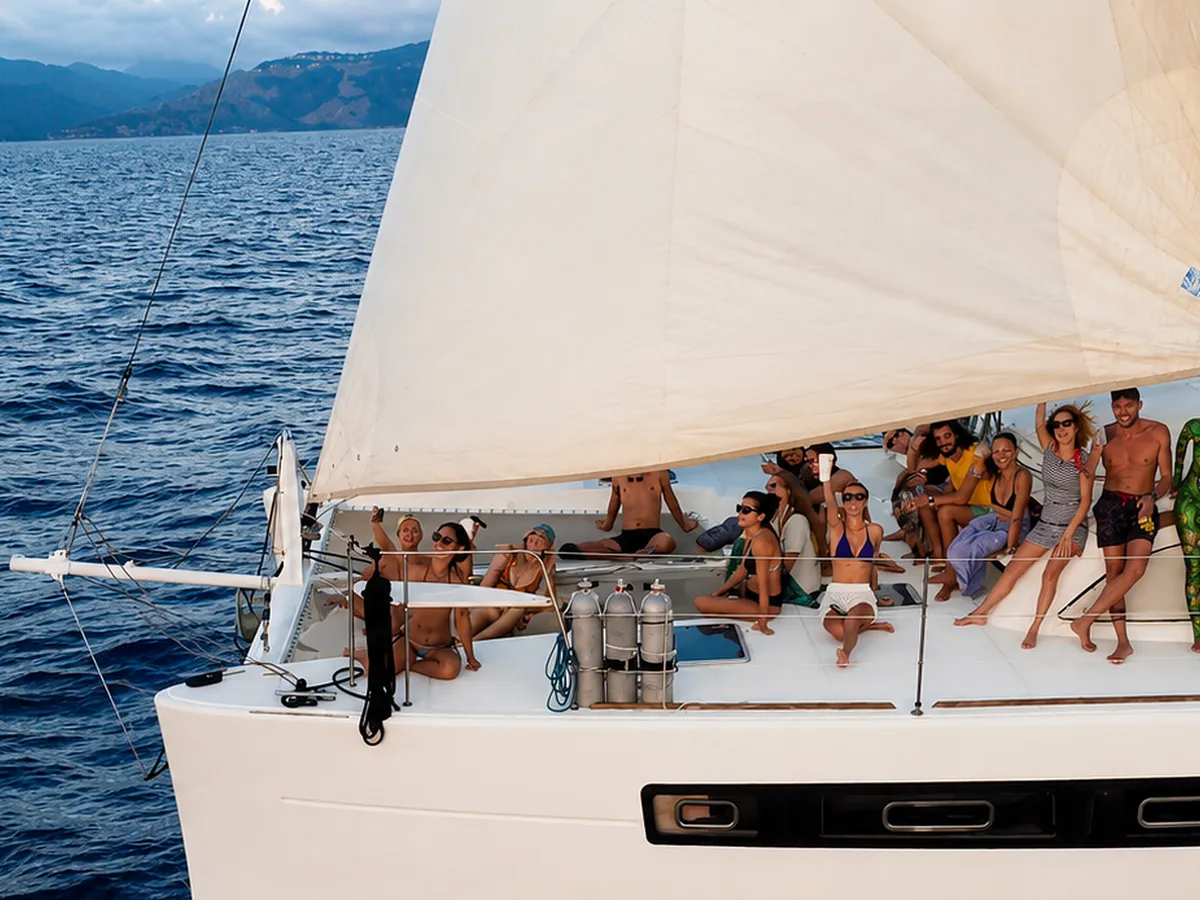 Guests and crew on the foredeck while Ikigai sails.